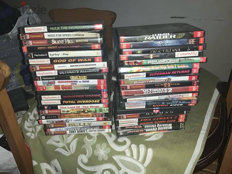 playstation 2 accessories and 137 game discs 4