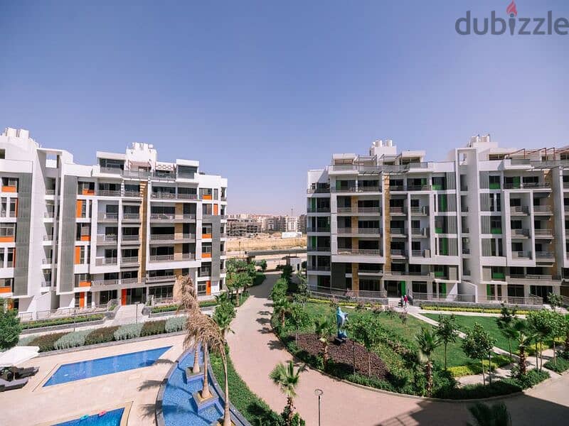 Apartment with garden for sale in Fifth Settlement, Golden Square, in icon Compound, with only 15% down payment 30% cash DIS | view of the landscape 20