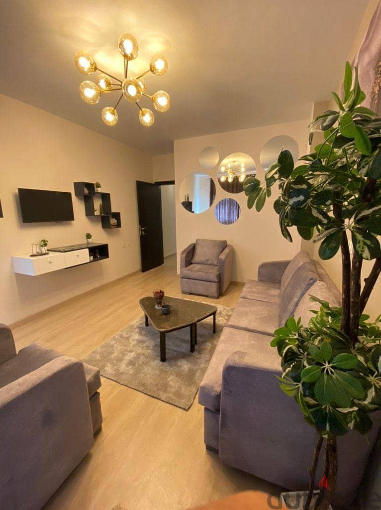 Apartment + garden for sale  finished with air conditioners, in a distinctive location in the heart of Sheikh Zayed, next to Hyper One 11