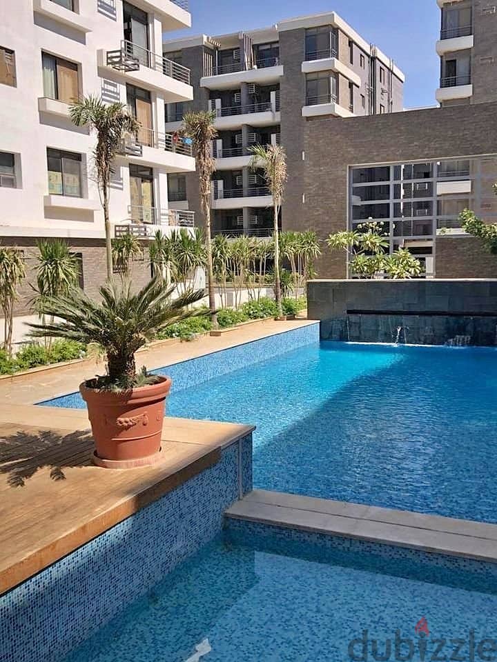 Luxurious apartment for sale, 224 square meters, with 4 bedrooms and a very distinctive view overlooking the landscape, located in front of Cairo Inte 7