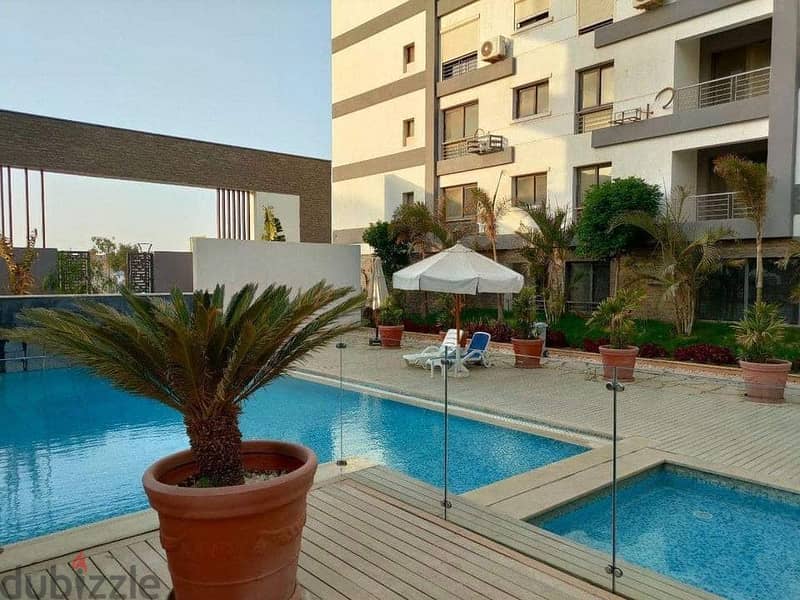 Luxurious apartment for sale, 224 square meters, with 4 bedrooms and a very distinctive view overlooking the landscape, located in front of Cairo Inte 10