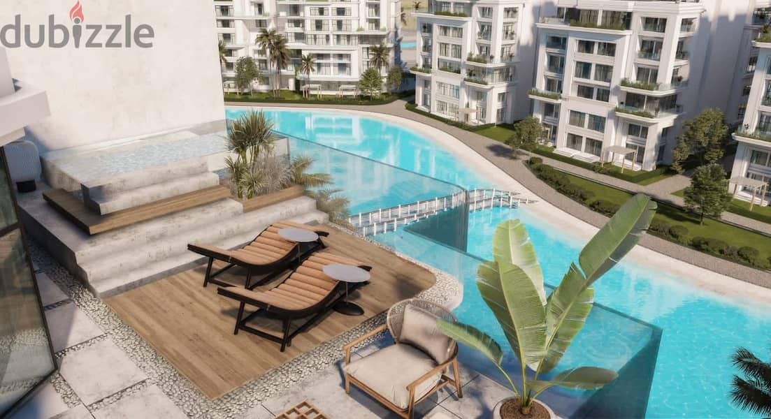 Ground floor apartment in a garden directly in front of the lagoon, with installments over 8 years, in a compound in the New Administrative Capital, R 1