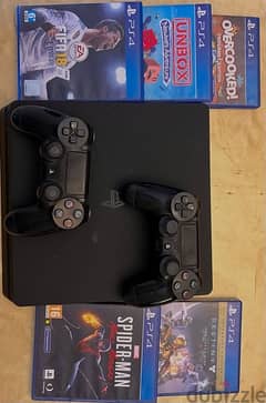 playstation 4 slim 1TB with 2 controllers and 5 CDs 0