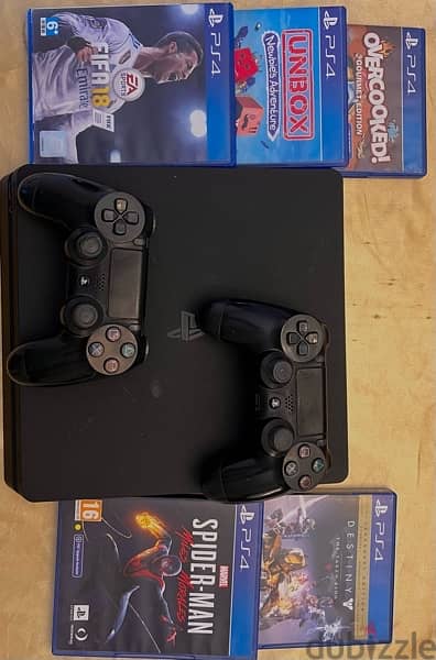 playstation 4 slim 1TB with 2 controllers and 5 CDs