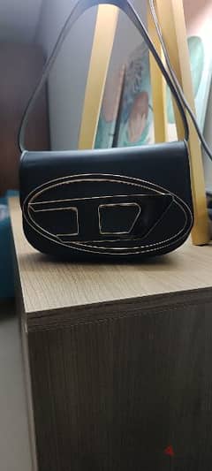 Black handbag with iconic D logo