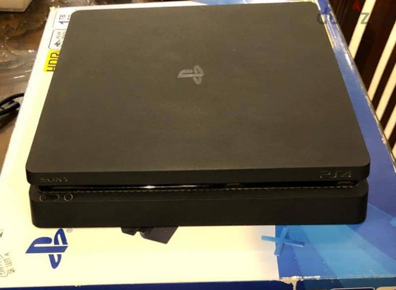 ps4 slim 1tb with original controller and an uncharted 4 CD 0