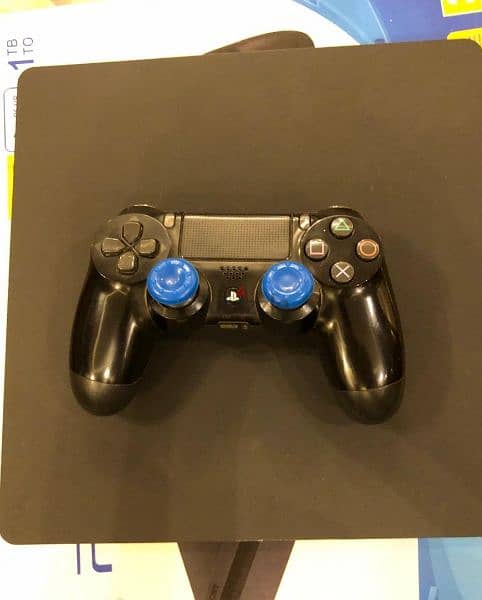 ps4 slim 1tb with original controller and an uncharted 4 CD 2