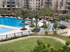 In Palm Hills New Cairo, a ground floor apartment with a garden, fully finished, Ultra Super Luxe, direct on the lagoon, for sale in Cleo Phase, Palm