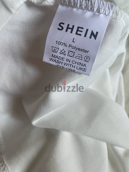 shein plain white top with a small iron burn size L 2