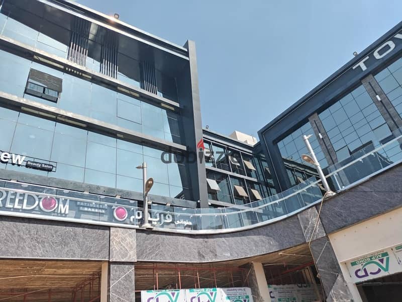 Shop for sale, ground floor, lower level, Town Center Mall, in the middle of the most famous brands with the highest traffic in Shorouk City, in insta 8