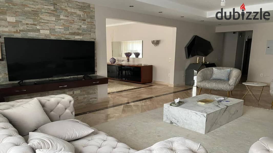 Ground floor apartment with garden, fully finished, directly on the lagoon, for sale in Palm Hills New Cairo Direct, directly on the ring road 2