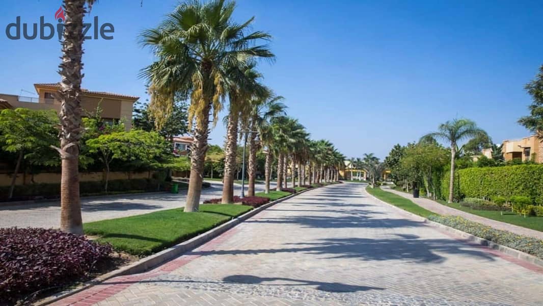 Ground floor apartment with garden, fully finished, directly on the lagoon, for sale in Palm Hills New Cairo Direct, directly on the ring road 6