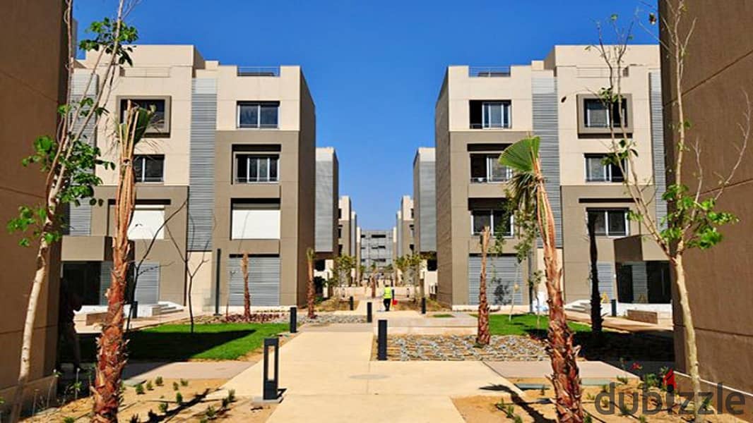 Ground floor apartment with garden, fully finished, directly on the lagoon, for sale in Palm Hills New Cairo Direct, directly on the ring road 7