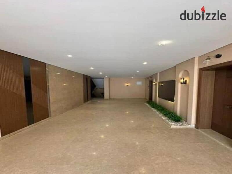 Apartment with garden fully finished with Acs for sale in compound Village west Elsheikh Zayed 5