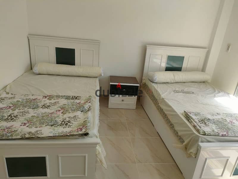 For rent, a furnished apartment with two air-conditioned rooms, special finishing, in front of services and buses 6