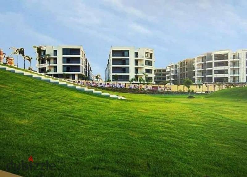 Ground floor apartment with garden for sale in installments in Taj City Compound 3