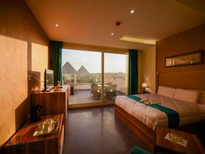 With a return of $100 per day, a two-room hotel apartment near the pyramids for sale in front of the Oasis Hotel in a built compound ready for viewing 0