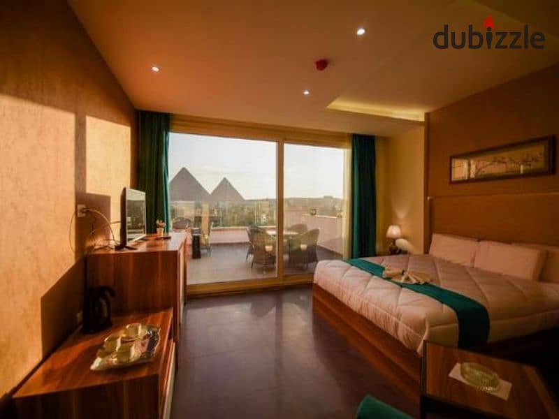 down payment of 280 k, hotel studio near the pyramids and directly in front of the Oasis Hotel for sale with a daily return in dollars in a compound r 1