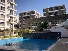 Apartment for sale in installments on a very special view on the landscape in front of Cairo Airport in the Taj City Compound 9