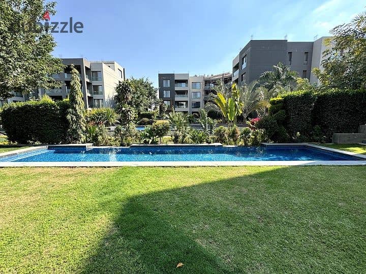 An apartment with a garden in a 1,000-acre compound with full services, in a special location in front of Cairo Airport, near Nasr City, Taj City. 2