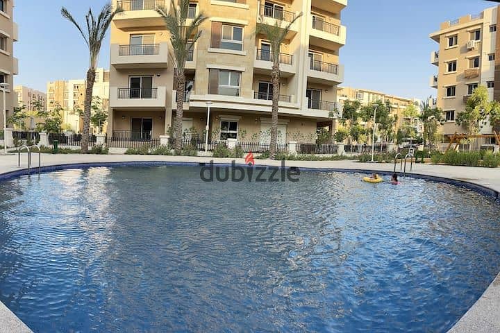 An apartment with a garden in a 1,000-acre compound with full services, in a special location in front of Cairo Airport, near Nasr City, Taj City. 10