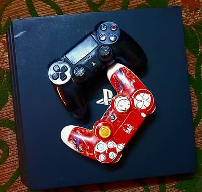 PS4 PRO WITH TWO CONTROLLERS AND 5 GAMES