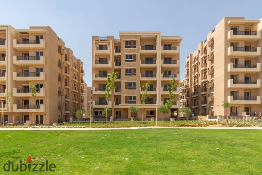 For sale at a snapshot price, a two-bedroom apartment with a garden, 115 m in Taj City, minutes from Nasr City 6