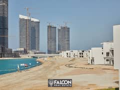 (Delivered within a year and a half) A fully finished villa with a10% down payment, first row on the sea next to El Alamein Towers in Mazarine, North 0