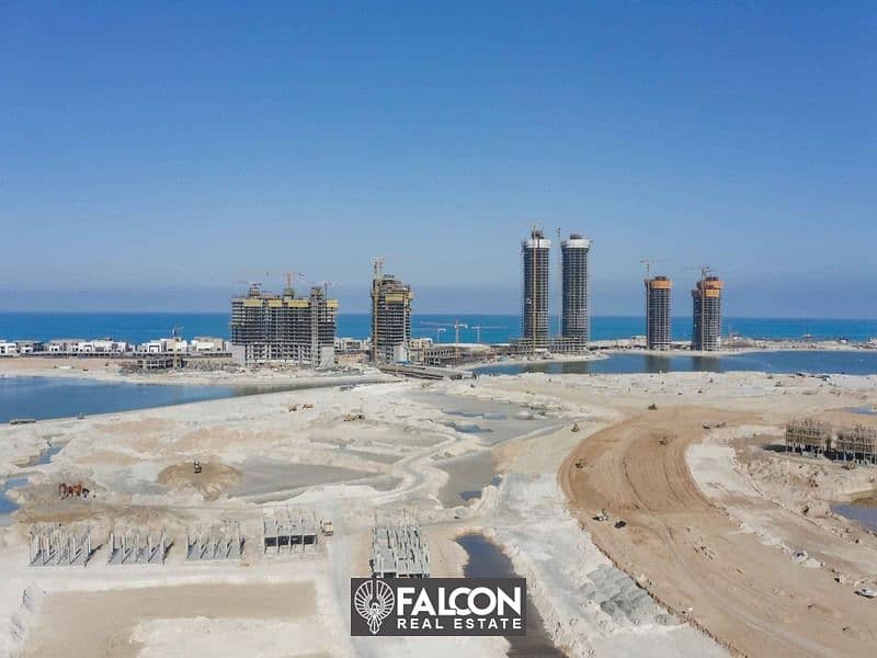 (Delivered within a year and a half) A fully finished villa with a10% down payment, first row on the sea next to El Alamein Towers in Mazarine, North 1