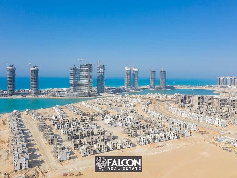 (Delivered within a year and a half) A fully finished villa with a10% down payment, first row on the sea next to El Alamein Towers in Mazarine, North 4