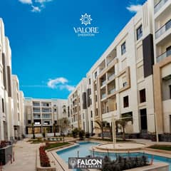 A fully finished two-room hotel apartment in front of Dar Al Ishara and next to Almaza City Center in the ALjar - Valore Compound. .