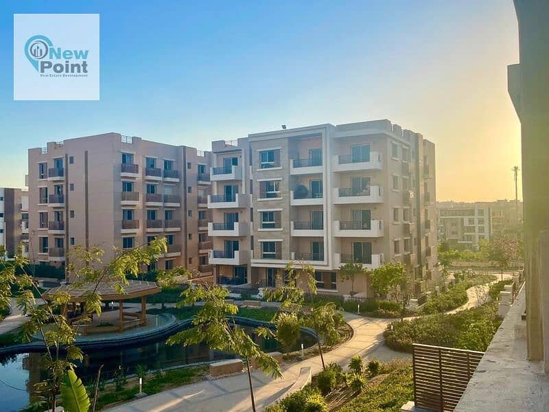 For sale, an apartment with a garden in Taj City, overlooking green spaces, minutes from Nasr City 3