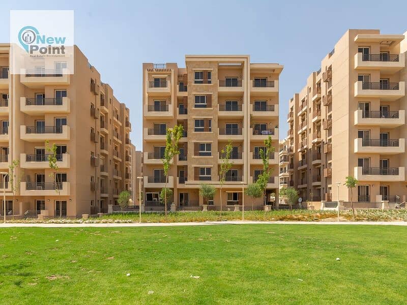 For sale, an apartment with a garden in Taj City, overlooking green spaces, minutes from Nasr City 9