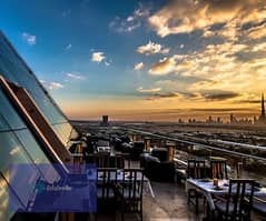 Sky Roof Restaurant and Café with a panoramic view of Al-Massa Hotel and the iconic tower in the shopping and recreation district and in front of the 0