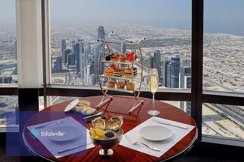 Sky Roof Restaurant and Café with a panoramic view of Al-Massa Hotel and the iconic tower in the shopping and recreation district and in front of the 1