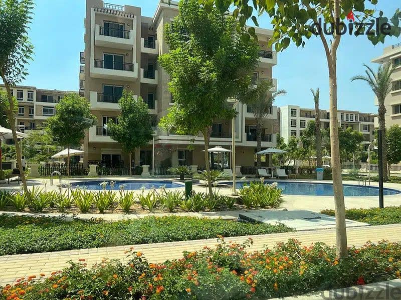 Apartment for sale in front of Cairo Airport, 115 sqm with a roof, located in Taj City Compound, Orgami Phase. 1