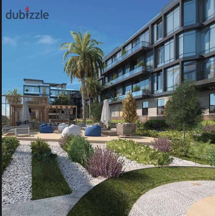 Live in a luxurious apartment with a garden, fully finished, in installments over 9 years, in the heart of old Sheikh Zayed, in UONE 22