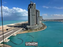 For sale, a hotel apartment with a direct sea view, fully finished (with air conditioning + hotel services) in El Alamein Towers on the North Coast