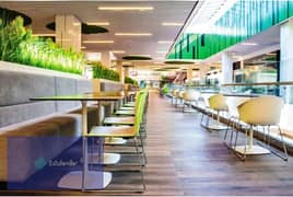 A food court store on the plaza building, immediate receipt, and a view of the iconic tower, in installments