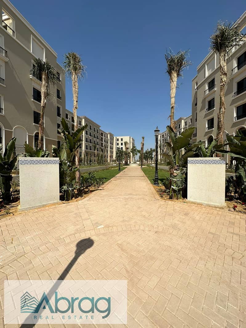 Ground floor apartment with garden for sale in Village West Compound - Sheikh Zayed 10