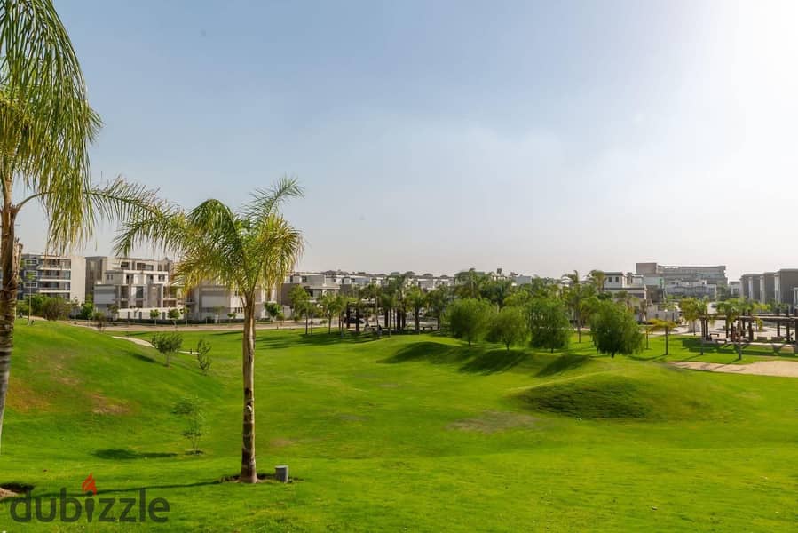 Apartment for sale in a private garden, in installments, on a very special view, on the Landscape, in front of Cairo Airport, in the Taj City Compound 3