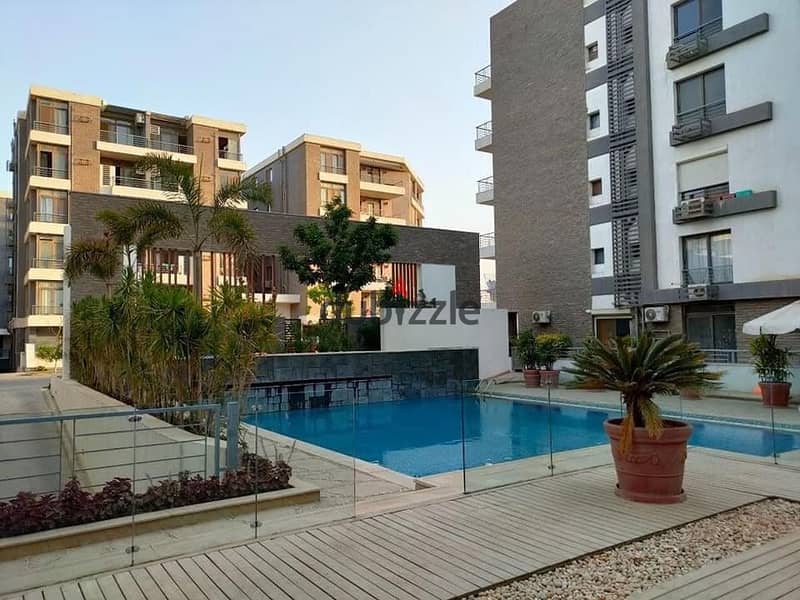 Apartment for sale in a private garden, in installments, on a very special view, on the Landscape, in front of Cairo Airport, in the Taj City Compound 6