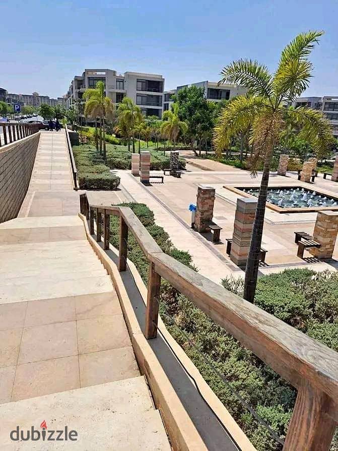 Apartment for sale in a private garden, in installments, on a very special view, on the Landscape, in front of Cairo Airport, in the Taj City Compound 7