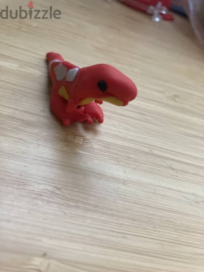 A hand made polymer clay dinosaur toy