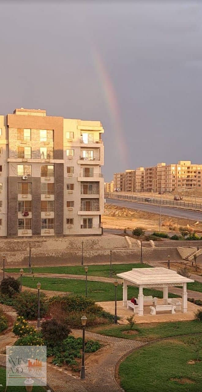 Receive an immediate finished apartment in Dar Misr Al Andalus, in front of 90th Street, and pay 2,700,000.130 apartment, a landscape view 6