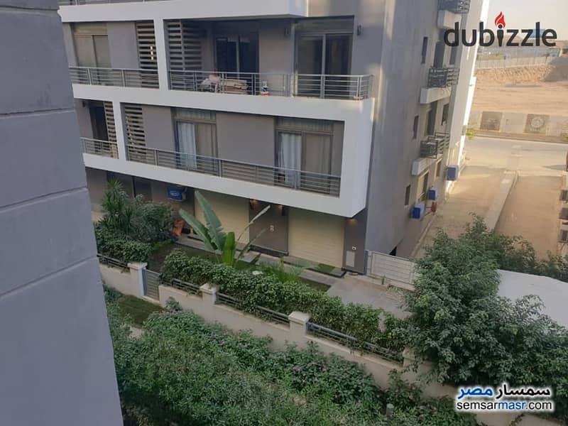 2 bedrooms with a garden of 120 meters in front of the airport inside the Taj City Compound for 900 thousand down payment, full services, in installme 12