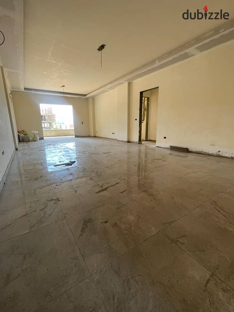 A very spacious apartment with a private garden, fully finished, located in front of Hani Village in Sheikh Zayed. 17