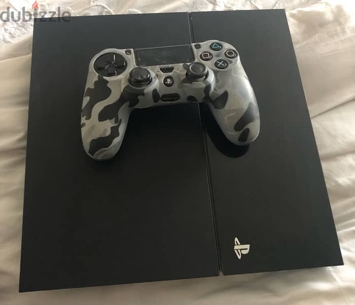 PlayStation 4 with controller 0