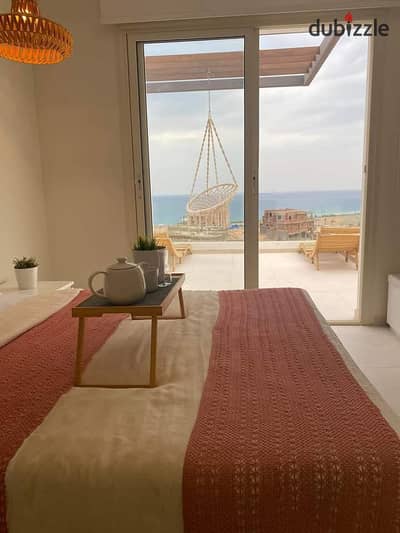 The last chalet to be delivered, 100 square meters on the sea, for sale in Ain Sokhna, in installments, The Groove, triple view, sea, lagoons and swim