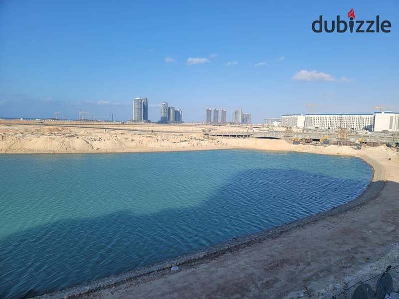 First row apartment directly on the lagoon  fully finished  immediate delivery  in front of El Alamein Towers in the Latin district 4